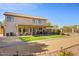 Backyard view with a covered patio, artificial grass, and a well-maintained landscape at 2130 E Knudsen Dr, Phoenix, AZ 85024