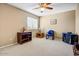 Spare bedroom with carpet, ceiling fan, and a bright window; ideal for a home office or guest bedroom at 2130 E Knudsen Dr, Phoenix, AZ 85024