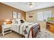 Cozy bedroom featuring carpet, a ceiling fan, and a comfortable bed with a decorative headboard and soft linens at 2130 E Knudsen Dr, Phoenix, AZ 85024