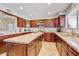 Spacious kitchen with dark wood cabinets, granite counters, a center island, and a stainless steel sink at 2130 E Knudsen Dr, Phoenix, AZ 85024