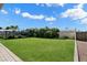 Lush backyard showcasing manicured green space, mature trees, and well-kept landscaping, perfect for outdoor enjoyment at 2205 E Fox St, Mesa, AZ 85213