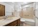 Tidy bathroom featuring a shower-tub combo, toilet, and wooden vanity with sink at 2205 E Fox St, Mesa, AZ 85213