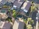 Aerial view showcasing neighborhood with sparkling pools, manicured yards, play areas, and covered patios at 28249 N Shundeen Cir, San Tan Valley, AZ 85143