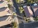 Aerial view of a neighborhood showcasing well-maintained homes, desert landscaping, and swimming pools at 28249 N Shundeen Cir, San Tan Valley, AZ 85143