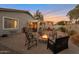 Backyard features a fire pit, desert landscaping, and plenty of seating under a colorful sky at 28249 N Shundeen Cir, San Tan Valley, AZ 85143