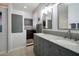 Modern bathroom boasts a double vanity, granite countertop, and a stylish tiled shower at 28249 N Shundeen Cir, San Tan Valley, AZ 85143