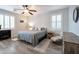 Relaxing bedroom with wood floors, a ceiling fan, and neutral decor for a serene atmosphere at 28249 N Shundeen Cir, San Tan Valley, AZ 85143