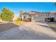 Well-maintained home with two-car garage and desert landscaping along the driveway to a welcoming front entrance at 28249 N Shundeen Cir, San Tan Valley, AZ 85143