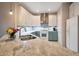 Modern kitchen features an undermount sink, white upper cabinets, gray-green lower cabinets and stainless steel appliances at 28249 N Shundeen Cir, San Tan Valley, AZ 85143