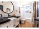 Charming bathroom featuring a vessel sink, black countertops and a shower-tub combo at 30439 W Peakview Rd, Wittmann, AZ 85361