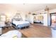 Serene main bedroom with hardwood floors, vanity, sitting area, and mirrored closet at 30439 W Peakview Rd, Wittmann, AZ 85361