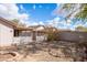 View of the home's backyard featuring a xeriscaped yard, covered patio, and a block wall for privacy at 3151 W Donald Dr, Phoenix, AZ 85027