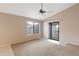 Bright bedroom features neutral carpet, ceiling fan, and a sliding glass door at 3151 W Donald Dr, Phoenix, AZ 85027