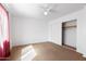 Bright bedroom with ceiling fan and closet features neutral carpet and white walls at 3151 W Donald Dr, Phoenix, AZ 85027