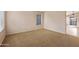 Inviting living room with neutral carpet, fan, and large windows for natural light at 3151 W Donald Dr, Phoenix, AZ 85027