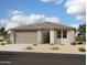 A well-maintained single-story home featuring a large two-car garage, gravel landscaping, and a covered entrance at 32637 N Newby Dr, San Tan Valley, AZ 85143