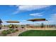 Community playground with shade canopies, bench seating, and a variety of play structures on a grassy lawn at 32637 N Newby Dr, San Tan Valley, AZ 85143