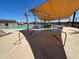 Resort-style community pool showcasing a splash pad and shaded lounge spots at 32637 N Newby Dr, San Tan Valley, AZ 85143