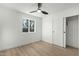 Minimalist bedroom featuring hard wood floors, a ceiling fan, and a window for natural light at 331 W Stanford Ave, Gilbert, AZ 85233