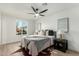 Bedroom features neutral tones, wood floors, a ceiling fan, and natural light from the window at 331 W Stanford Ave, Gilbert, AZ 85233