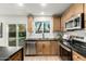 Bright kitchen with stainless steel appliances, light wood cabinets, and black countertops at 331 W Stanford Ave, Gilbert, AZ 85233