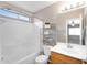 Bathroom featuring a shower-tub combo, storage shelves, and a modern vanity at 34717 N Picket Post Dr, San Tan Valley, AZ 85144