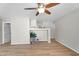 Open living room with wood-look floors, neutral paint, and modern ceiling fan at 34717 N Picket Post Dr, San Tan Valley, AZ 85144