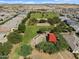 Aerial view of neighborhood featuring homes, green spaces, and a playground at 36860 W Santa Maria St St, Maricopa, AZ 85138