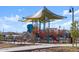 Community playground featuring a slide, jungle gym, and shade structure at 36860 W Santa Maria St St, Maricopa, AZ 85138