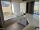 Bathroom featuring a bathtub with a window, with double sinks and a large vanity at 3703 N Wintergreen Way, Avondale, AZ 85392