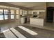 Open-concept kitchen featuring white cabinets, stainless steel appliances, and a breakfast bar overlooking the living area at 3703 N Wintergreen Way, Avondale, AZ 85392