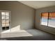 Bright living room with a door to the exterior of the house and large awning-covered window at 3703 N Wintergreen Way, Avondale, AZ 85392