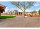 Spacious backyard with a covered patio, artificial grass, desert landscaping, and mountain views at 3826 E Equestrian Trl, Phoenix, AZ 85044