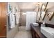 Bright bathroom showcases double sinks, stylish mirrors, and a tiled shower with a white shower curtain at 3826 E Equestrian Trl, Phoenix, AZ 85044