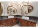 Stylish bathroom features double sinks, unique mirrors and vanity lighting at 3826 E Equestrian Trl, Phoenix, AZ 85044