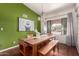 Bright dining room featuring a green accent wall, hardwood floors, and unique decor at 3826 E Equestrian Trl, Phoenix, AZ 85044