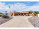 A single-story house featuring desert landscaping, blue potted plants, and warm exterior paint at 3826 E Equestrian Trl, Phoenix, AZ 85044