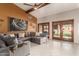 The modern living room features a vaulted ceiling, a gray sectional sofa, and French doors at 3826 E Equestrian Trl, Phoenix, AZ 85044