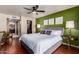 Spacious main bedroom featuring an accent wall, ceiling fan, and ensuite bathroom at 3826 E Equestrian Trl, Phoenix, AZ 85044