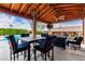 Covered patio featuring an outdoor dining set and living area with a ceiling fan at 3826 E Equestrian Trl, Phoenix, AZ 85044