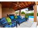 Outdoor living space with a ceiling fan, a TV, patio furniture, and a view of the pool at 3826 E Equestrian Trl, Phoenix, AZ 85044