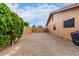 A side yard with gravel landscaping, privacy fencing, and an air conditioning unit at 3826 E Equestrian Trl, Phoenix, AZ 85044