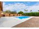 An in-ground swimming pool surrounded by a concrete patio and desert landscaping at 3826 E Equestrian Trl, Phoenix, AZ 85044