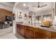 A home wet bar features wood cabinetry, granite countertops, and modern lighting fixtures at 3826 E Equestrian Trl, Phoenix, AZ 85044