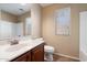 Bathroom features a single sink vanity with a mirror and a window at 383 E Jasper Dr, Chandler, AZ 85225