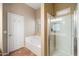 Bright bathroom featuring a soaking tub and a glass-enclosed shower at 383 E Jasper Dr, Chandler, AZ 85225