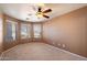 Cozy bedroom featuring carpeted floors, neutral walls, and a ceiling fan for comfortable living at 383 E Jasper Dr, Chandler, AZ 85225