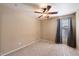 Neutral bedroom featuring a ceiling fan and a window with curtains at 383 E Jasper Dr, Chandler, AZ 85225