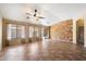 Bright living room featuring tile floors, neutral walls, ceiling fan, and sliding glass doors to the backyard at 383 E Jasper Dr, Chandler, AZ 85225