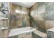 Close up of bathroom features including tile backsplash, rain shower head and a tub at 4026 E Captain Dreyfus Ave, Phoenix, AZ 85032